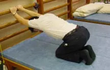 Fig. 1 from Cheung 2005: Forward arm stretching in prone kneeling.