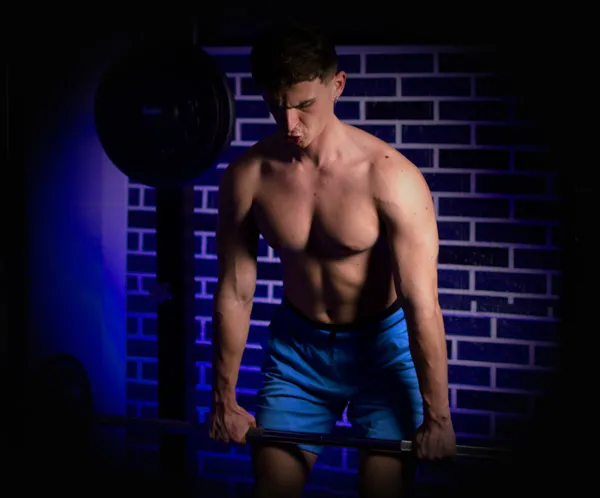 Mihail training with a barbell, mid-set