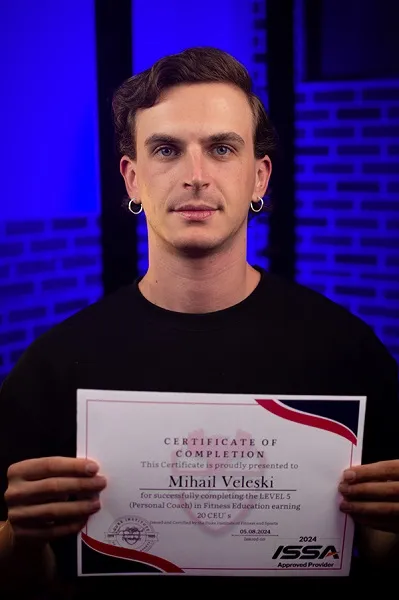 Mihail Veleski holding his Level 5 Certificate of Completion in fitness education